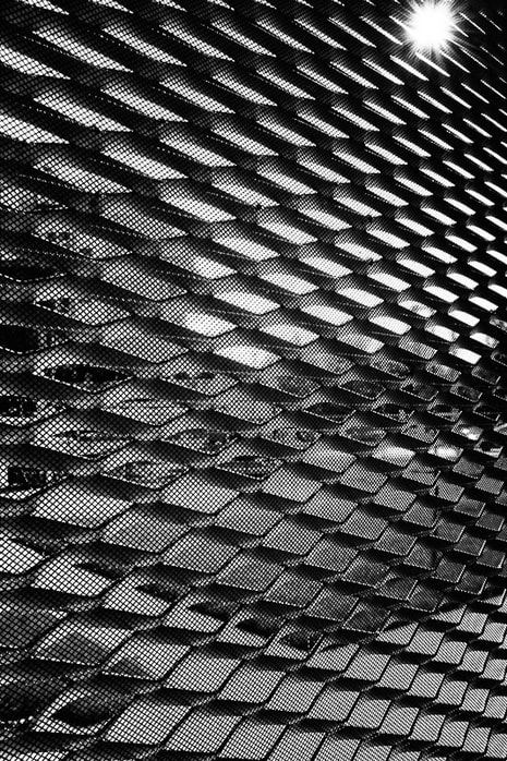Street photography. Black and white cityscape through grid.